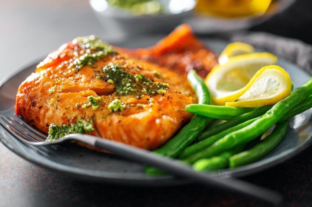 Closeup of baked salmon fish with green beans